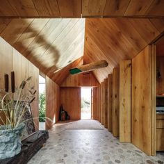 the inside of a house with wood walls and flooring on both sides of it