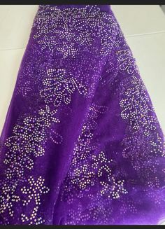 a purple dress with silver beads on it