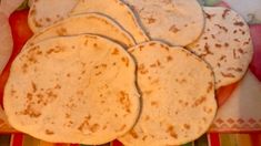 four tortillas on a colorful plate with napkins