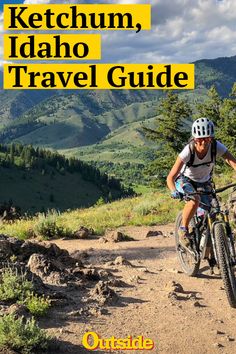 a man riding a mountain bike down a dirt road next to trees and mountains with the words ketchum, idaho travel guide