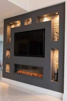 a living room with a flat screen tv mounted on the wall and built - in fireplace