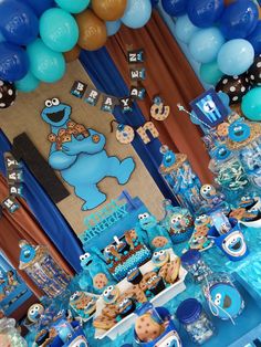 a blue and brown dessert table with balloons