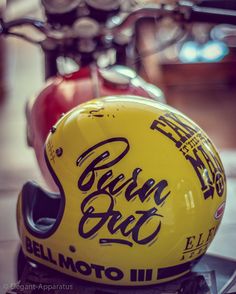 a yellow motorcycle helmet sitting on top of a table