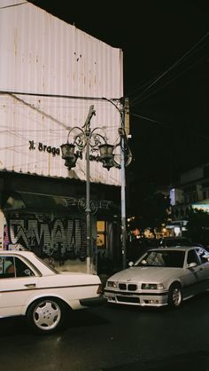 two cars parked in front of a building