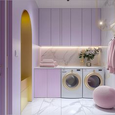 a washer and dryer in a room with purple walls, marble flooring and gold accents