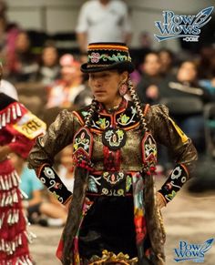 two women in native clothing standing next to each other with their hands on their hips