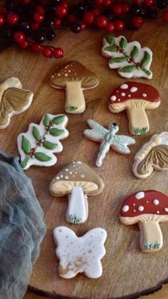 decorated cookies are arranged on a wooden platter