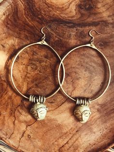 "Handmade brass hoops featuring African masks and textured brass beads that were made by African artisans. *The mask on each pair of hoops will vary is style and size. No 2 are alike. DETAILS: Metal: Brass Size:3\" Gold plated ear wire Ships with polishing cloth *The mask and beads have been left un-polished and May feature some patina. Return to shop: Afrohemien.etsy.com Like and Follow Afrohemien for updates, sales, coupons and surprise giveaways Instagram/Blog: instagram.com/Afrohemien Tumblr Festive Brass Hoop Earrings With Ear Wire, Bohemian Hammered Hoop Earrings, Spiritual Brass Hoop Earrings, Bohemian Bronze Hoop Earrings In Brass, Bohemian Bronze Brass Hoop Earrings, Bohemian Brass Hoop Earrings For Festive Occasions, Festival Bronze Brass Hoop Earrings, Bohemian Hammered Brass Hoop Earrings, Bohemian Small Hoop Hand Forged Earrings