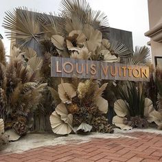 the entrance to louis vuitton is surrounded by plants