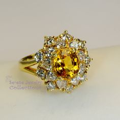 Thank you for coming in! This Vintage Ring has a strong striking yellow sapphire as its center piece. The sapphire is bezel set into a fancy setting with 8 heart and 8 round diamonds totaling 1.8 carats! Ring Size: 7.75 Total Weight: 9.58 grams Precious Metal: 18k solid gold Precious stones: -Yellow Sapphire: 2.92 carats, 9mm x 7.3mm -White Round Diamonds: 1.8 ct Hallmark: A18K Luxury Multi-stone Yellow Gemstones, Luxury Yellow Multi-stone Gemstones, Yellow Multi-stone Round Gemstones, Yellow Multi-stone Sapphire Ring, Luxury Yellow Multi-stone Jewelry, Yellow Sapphire Ring With Center Stone In Yellow Gold, Luxury Yellow Gemstones With Accent Stones, Yellow Multi-stone Diamond Ring In Fine Jewelry Style, Yellow Multi-stone Diamond Ring Fine Jewelry