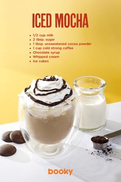 an advertisement for iced mocha with chocolate and whipped cream on the table next to it