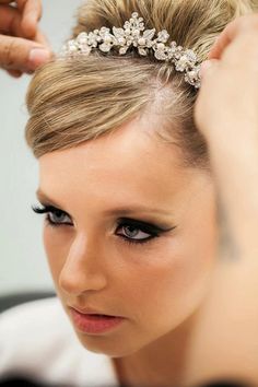 a woman is getting her hair done