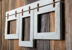 an old window is hanging on the side of a wooden wall