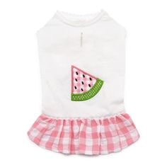 a dog wearing a white shirt and pink gingham skirt with watermelon on it