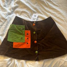 New With Tags! Trendy Brown Green Orange Skirt, Size Small. Really Cute With Velvet Suede Feel Casual Orange Mini Length Skort, Casual Orange Mini Skort, Retro Brown Skirt With Pockets, Fall Patchwork Brown Skirt, Retro Brown Skirt, Spring Brown Patchwork Skirt, Orange Mini Skirt Bottoms With Pockets, 70s Corduroy Skirt, Orange Mini Skirt With Pockets