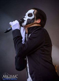 a man wearing a mask and holding a microphone