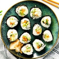 sushi on a plate with chopsticks next to it