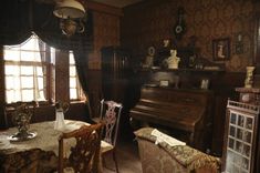 an old fashioned living room with antique furniture