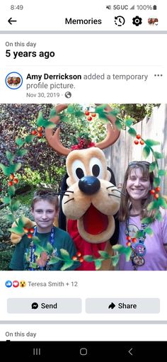 two children and an adult posing for a photo in front of goofy the reindeer mascot