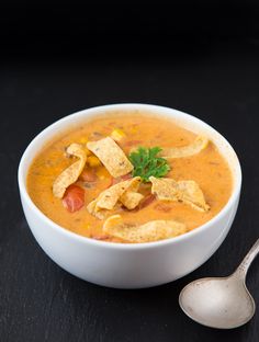 a white bowl filled with soup and tortilla chips