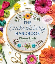 an embroidery book with flowers and scissors on the cover, surrounded by other crafting supplies