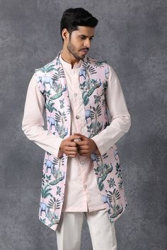 Light pink kurta with mandarin collar. Comes with churidar and jacket.
Components: 3
Fabric: Cotton, Silk
Neckline: Kurta: Band collar
Sleeve Length: Kurta: Full; Jacket: Sleeveless
Color: Pink
Lining material: Poly
Digital printed motifs on jacket
Closure: Front button placket on kurta
Note: Pant worn by the model is not for sale - Aza Fashions White Churidar, Pink Kurta, Kurta Set For Men, Nehru Jackets, Cotton Kurta, Silk Jacket, Pink Jacket, Band Collar, Churidar