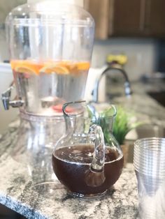 the pitcher is filled with liquid on the kitchen counter