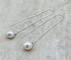 "Precious baroque white keshi pearls suspending from a 925 sterling silver threader. LENGTH: 2.8 inches - 7 cm long - 4,2 gr. each Pearls: 7 x 9 mm These dainty earrings are also available in 24 K Gold Vermeil https://www.etsy.com/uk/listing/1016226928/gold-vermeil-threaders-with-baroque?ref=shop_home_active_16&pro=1&frs=1 MATERIALS: 925 Sterling Silver Baroque pearls: Pearl signifies faith, charity and innocence. It enhances personal integrity and helps to provide a focus to ones attent Minimalist Sterling Silver Pearl Chain Earrings, Sterling Silver Pearl Chain Earrings For Gift, Gift Pearl Chain Earrings In Sterling Silver, Sterling Silver White Pearl Chain Earrings, Sterling Silver White Pearl Earrings With Pearl Chain, White Sterling Silver Pearl Chain Earrings, Gift Sterling Silver Pearl Chain Earrings, Jewellery Minimalist, Personal Integrity