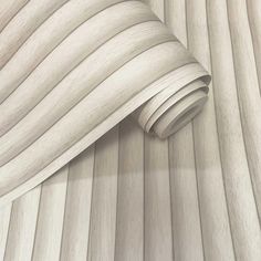 a close up view of a white wood wallpaper with wavy lines on the surface