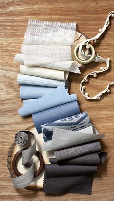 several different colors of fabric laid out on a table next to a key chain and ring