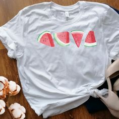 ** Cottage core watermelon tee - unisex ** Check sizing chart prior to ordering ** Visit our shoppe at:  ThePawPrintShoppe.etsycom This unisex t-shirt is a beautiful piece of clothing designed for those who love the refreshing and colorful look of watermelon slices. The shirt features a graphic design of watermelon slices that has been printed onto soft, high-quality cotton fabric. The cotton material used for this t-shirt is very soft to the touch, making it comfortable to wear for extended per Green Summer Shirt With Funny Print, Summer Red Pre-shrunk Shirt, Red Fruit Print Tops For Summer, Pre-shrunk Red Summer Shirt, Red Pre-shrunk Shirt For Summer, Red Cotton T-shirt For Vacation, Summer Strawberry Print Short Sleeve Tops, Red Summer Tops With Screen Print, Pink Strawberry Print Summer Shirt