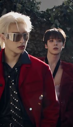 two young men wearing sunglasses and red jackets