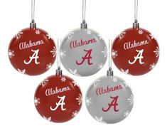 four christmas ornaments with the university of alabama logo on each ornament and snowflakes