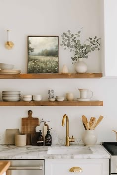 the shelves above the kitchen sink are filled with dishes