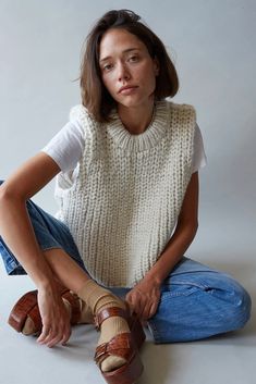 a woman sitting on the floor with her legs crossed