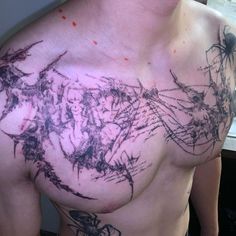 a man's chest is covered with ink