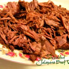 shredded beef on a plate with flowers and floral design around the edges, ready to be eaten