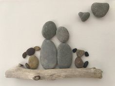 some rocks are sitting on top of a branch