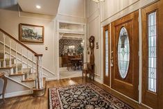 an entry way with stairs and stained glass windows