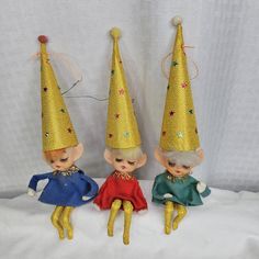 three little dolls wearing party hats on top of each other