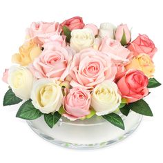 a glass bowl filled with lots of pink and yellow roses