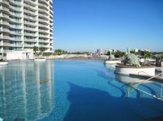 an empty swimming pool next to a tall building