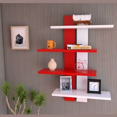 three shelves with pictures and other items on them in a room that has striped walls