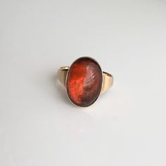 A vintage 9 carat yellow gold cabochon amber ring. This fossilised tree resin has a lovely colour. CONDITION: Great condition, wear consistent with age and use. A couple of scratches. Please see photos for more detail. SETTING/STONE SIZE: 17mm x 11mm BAND WIDTH: 3mm SETTING AND STONE HEIGHT: 5mm RING SIZE: UK: N 1/2 | US: 7 WEIGHT: 3.2g grams (UTZ) Formal Orange Cabochon Ring, Brown Oval Cabochon Rings, Vintage Oval Moonstone Ring With Polished Finish, Formal Brown Cabochon Rings, Formal Amber Oval Cabochon Rings, Vintage Rings With Natural Inclusions For Gift, Classic Orange Oval Cabochon Rings, Formal Orange Oval Cabochon Ring, Vintage Oval Cabochon Opal Ring Gift