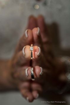 a woman's hands holding an engagement ring