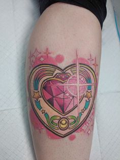 a woman's leg with a tattoo on it that has a heart in the center