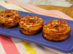 three small pastries on a blue plate