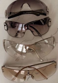 three pairs of sunglasses sitting on top of each other