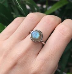 "A Boho Iridescent Round Smooth Genuine Natural Labradorite Sterling Silver Ring featuring a comfort fit band with a bezel around the stone. PLEASE NOTE Labradorite will vary in color as each gemstone is unique. This is a mesmerizing gemstone known for it's flash. Wrapped in a box ready for gift giving.(r-497) RING INFO ---------------- STERLING SILVER Stone 10MM (0.39inches) High Quality Sterling Silver 925 Tarnish Resistant *Model is wearing a size 5 *Follow us @belesasjewelry on Instagram for Blue Gemstone Engagement Rings, Blue Sapphire Promise Ring, Sapphire Promise Rings, Color Changing Ring, Rose Gold Ring Set, September Birthstone Rings, Blue Engagement Ring, Mood Ring, Alexandrite Ring