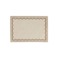 a beige and brown place mat with scalloped edges on the bottom, in front of a white background